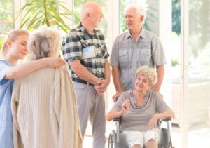 A clinician parts ways with a chronically ill resident, leaving room for another next health related visitor who is in a wheelchair.