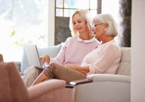 An elderly woman and younger woman discuss a move to assisted living at Culpepper Place.