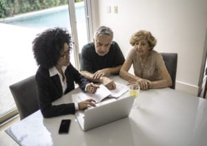 A senior couple meets with an advisor to plan for long-term care.