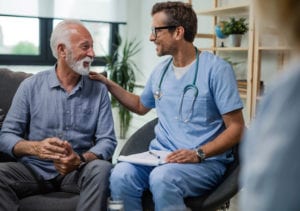 A senior receives care from a medical professional in assisted living.
