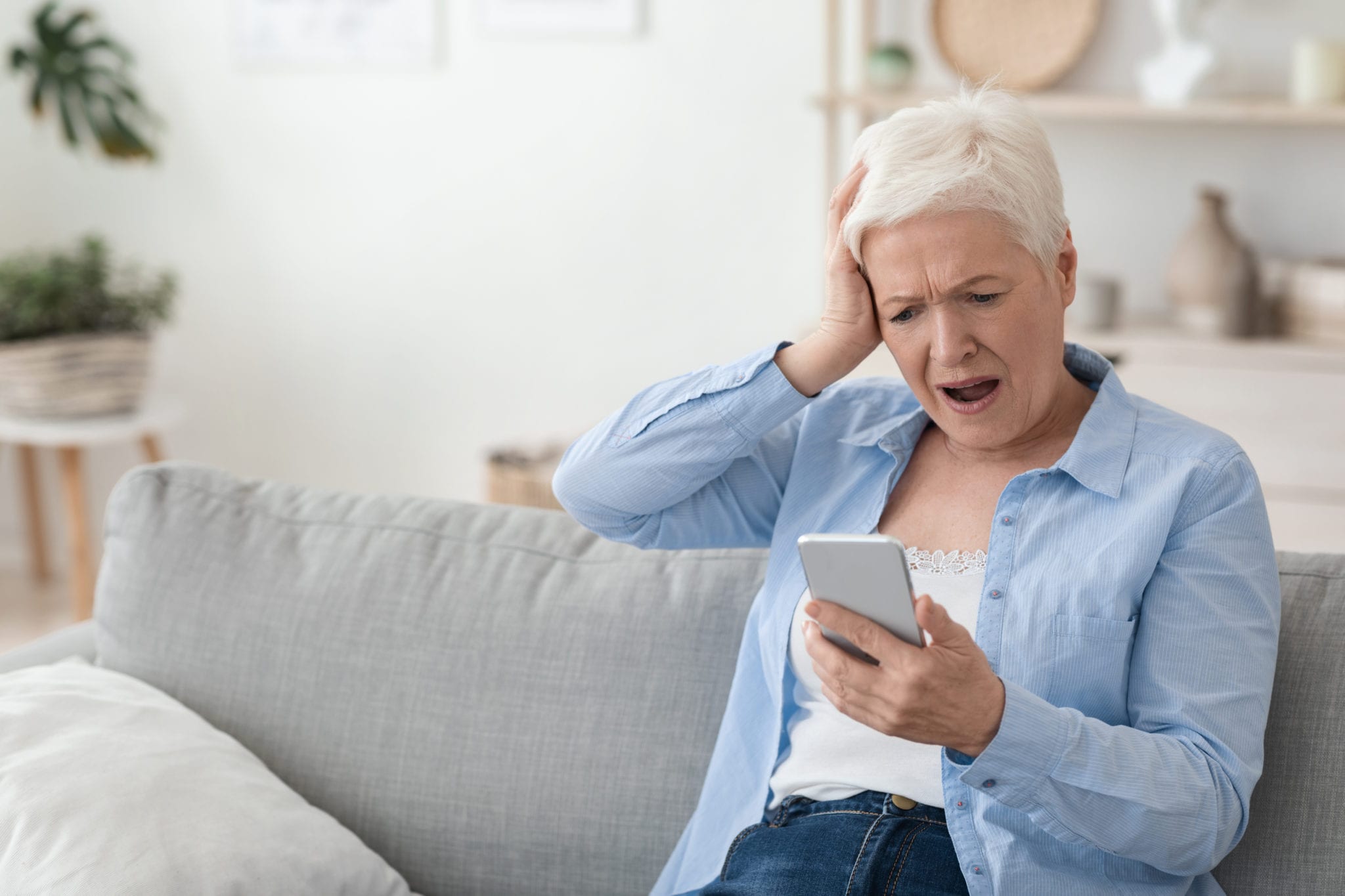 A woman reacts to being scammed online.