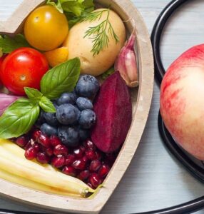 Foods that promote healing after surgery in a heart-shaped bowl with a stethoscope.