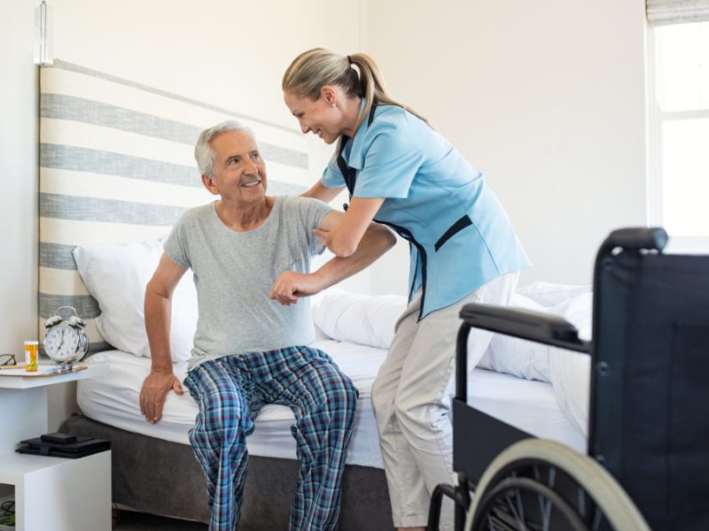 A nurse evaluates an elderly man for activities of daily living.