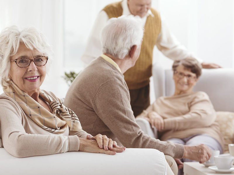 Two senior couples enjoying spending time together and discussing assisted living statistics
