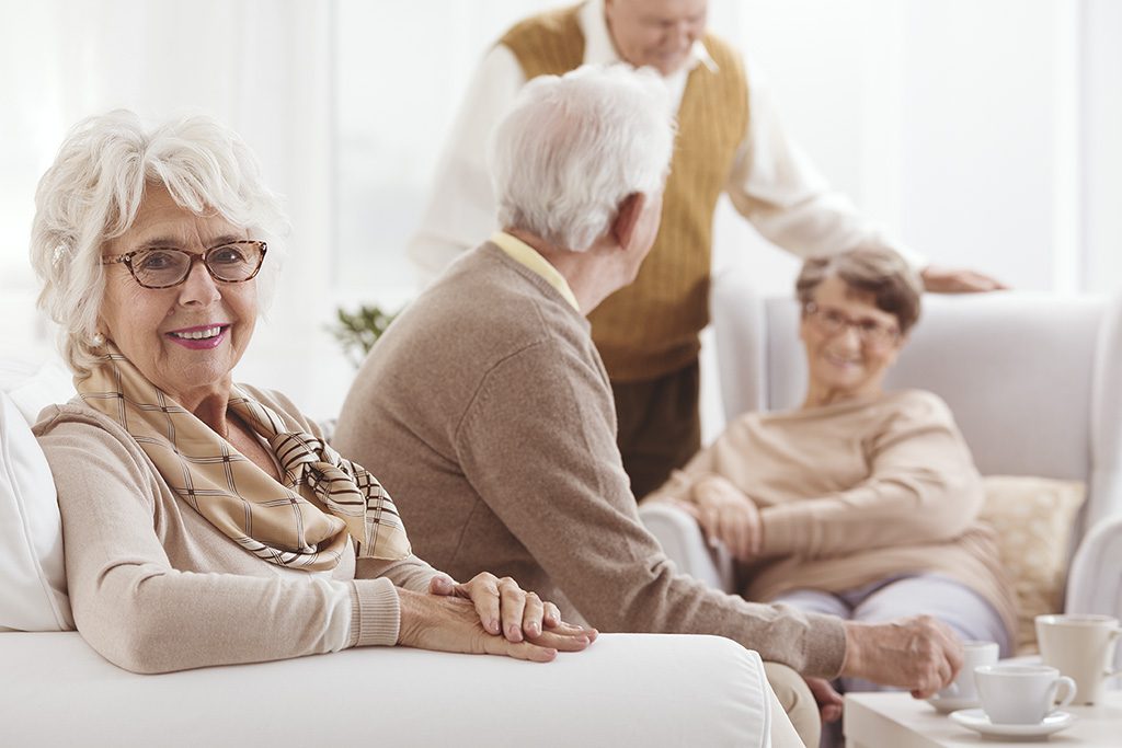 Two senior couples enjoying spending time together and discussing assisted living statistics